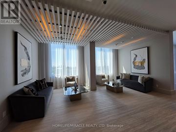 Toronto (Humewood-Cedarvale) condo for rent - A living room with a black couch and a wooden floor.