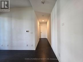 Toronto (Humewood-Cedarvale) condo for rent - A long hallway with white walls and a wooden floor.
