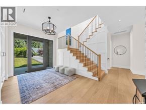 West Vancouver apartment for rent - A spacious living room with a staircase leading to the upper floor.
