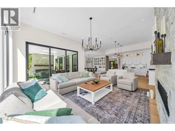 West Vancouver apartment for rent - A living room with a white couch and a chandelier.