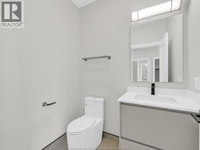 Lasalle condo for rent - A white toilet sits next to a sink in a bathroom.