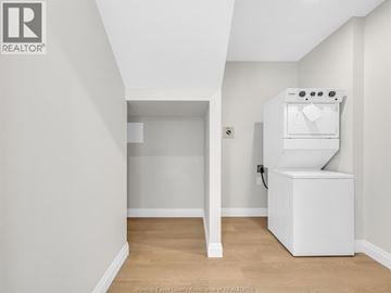 Lasalle condo for rent - A white kitchen appliance sits in a corner of a white room.