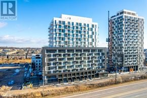 Oakville (Jm Joshua Meadows) condo for rent - A real estate company logo is displayed on a building under construction.