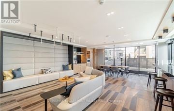 Oakville (Jm Joshua Meadows) condo for rent - A modern living room with a white sofa and a coffee table.