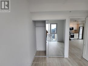 Hamilton (Corktown) condo for rent - A room with a sliding glass door leading to a balcony.