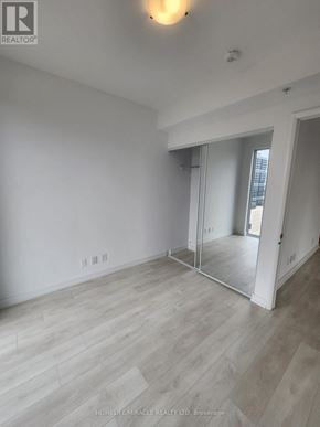 Hamilton (Corktown) condo for rent - A room with a sliding glass door and wood flooring.