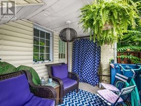 Toronto (East End-Danforth) apartment for rent - A patio with a purple couch and a blue chair.