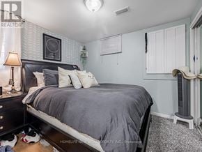 Toronto (East End-Danforth) apartment for rent - A bedroom with a bed, nightstand, and a lamp.