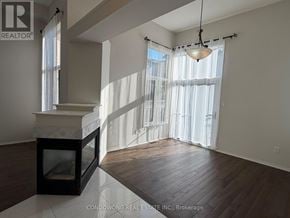 Richmond Hill (Rouge Woods) apartment for rent - A large, empty room with a fireplace and wooden floors.