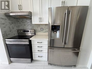 Richmond Hill (Rouge Woods) apartment for rent - A stainless steel refrigerator with a digital display is in the foreground of a kitchen.