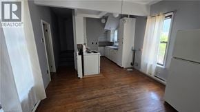 Listowel apartment for rent - A realtor sign is on the wall in a kitchen.