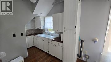 Listowel apartment for rent - A white kitchen with a sink and cabinets.