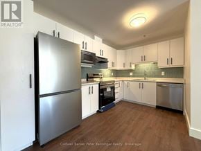 Arran-Elderslie townhouse for rent - A modern kitchen with a stainless steel refrigerator and wooden flooring.