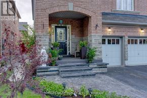 Ajax (Northeast Ajax) apartment for rent - A brick house with a front yard and a sign that says REALTOR.
