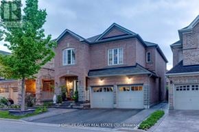 Ajax (Northeast Ajax) apartment for rent - A large brick house with a tree in front and a sign that says "HOMELIFE GALAXY REAL ESTATE LTD., Brokerage".