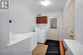 Ajax (Northeast Ajax) apartment for rent - A small white bathroom with a toilet, sink, and bathtub.