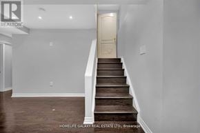 Ajax (Northeast Ajax) apartment for rent - A staircase in a house with a white wall and wooden steps.
