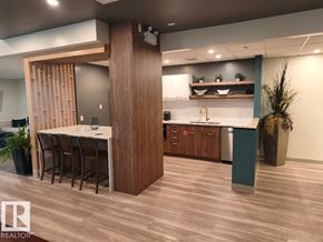 Edmonton apartment for rent - A modern kitchen with a dining table and chairs.