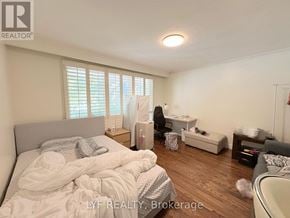 Markham (Unionville) apartment for rent - A bedroom with a bed, a chair, and a small table.