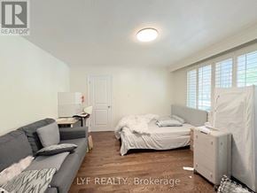 Markham (Unionville) apartment for rent - A bedroom with a bed, a couch, and a window with blinds.