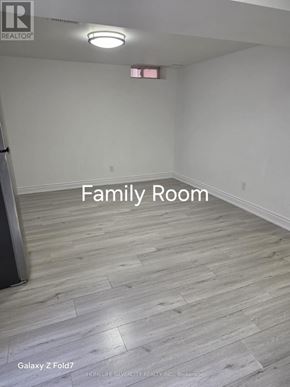 Vaughan (Maple) apartment for rent - A family room with wood flooring and a white wall.