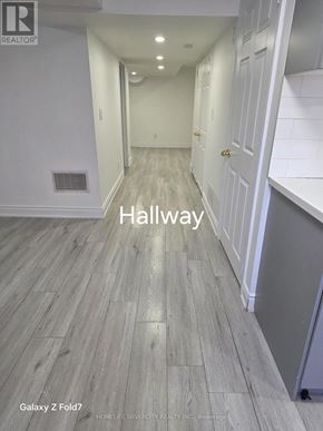 Vaughan (Maple) apartment for rent - A hallway with wood flooring and white walls.