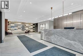 Kitchener condo for rent - A reception area with a marble counter and a row of chairs.