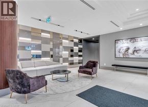 Kitchener condo for rent - A modern waiting room with a purple chair and a grey sofa.