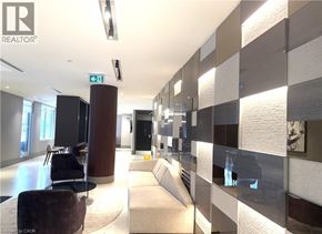 Kitchener condo for rent - A modern office lobby with a glass wall and a brown column.