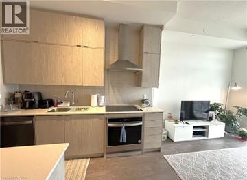 Kitchener condo for rent - A modern kitchen with wooden cabinets and a white countertop.