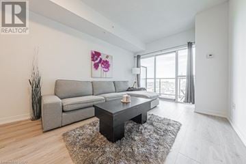 Grimsby (Grimsby Beach) condo for rent - A living room with a grey sofa and a coffee table.