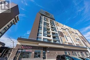 Grimsby (Grimsby Beach) condo for rent - A tall apartment building with a bakery on the ground floor.