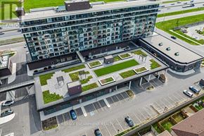 Grimsby (Grimsby Beach) condo for rent - A modern building with a parking lot in front of it.