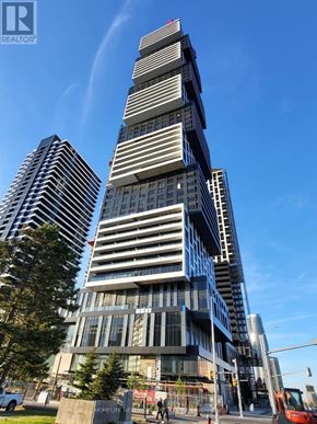 Mississauga (City Centre) condo for rent - A tall building with a unique design is under construction.