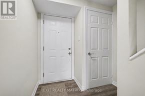 Ottawa townhouse for rent - A white door with a handle and a window above it.