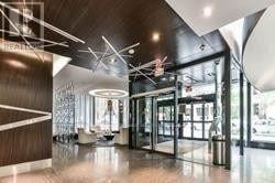 Toronto (Church-Yonge Corridor) condo for rent - A modern interior space with a curved ceiling and a glass wall.