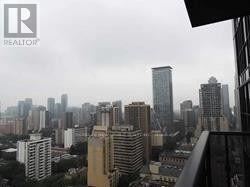 Toronto (Church-Yonge Corridor) condo for rent - A cityscape with tall buildings and a cloudy sky.
