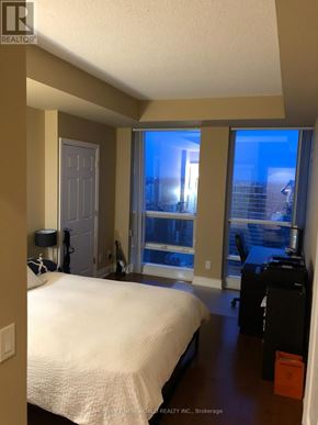 Toronto (Bay Street Corridor) condo for rent - A bedroom with a bed, desk, and window.