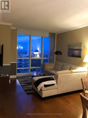 Toronto (Bay Street Corridor) condo for rent - A living room with a couch, a chair, and a television.