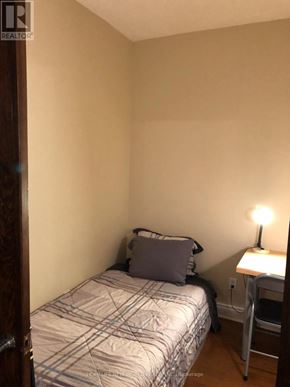 Toronto (Bay Street Corridor) condo for rent - A bedroom with a bed, a desk with a lamp, and a chair.