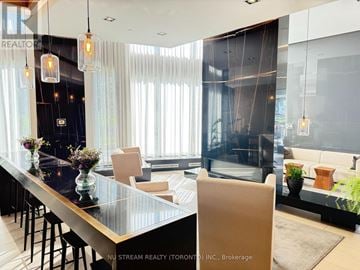 Toronto (Thorncliffe Park) condo for rent - A modern living room with a glass table and a bar area.