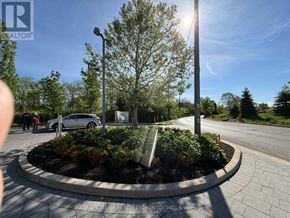Toronto (Thorncliffe Park) condo for rent - A roundabout with a sign that says "NO STREAM REALTY TRONTOJ INC. Brokerage" in the middle of it.