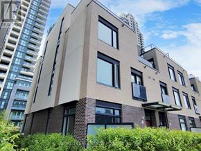 Mississauga (Creditview) townhouse for rent - A modern building with a mix of brick and panel construction stands in front of taller buildings.