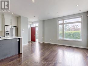 Mississauga (Creditview) townhouse for rent - A spacious kitchen with wooden floors and a red door.