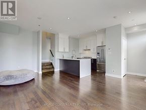 Mississauga (Creditview) townhouse for rent - A spacious kitchen with wooden floors and white walls.