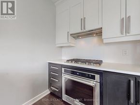 Mississauga (Creditview) townhouse for rent - A kitchen with white cabinets and a black oven.