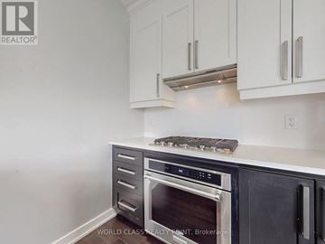Mississauga (Creditview) townhouse for rent - A kitchen with white cabinets and a black oven.