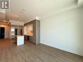 Toronto (Bayview Village) condo for rent - A spacious room with a kitchenette and a bar area.