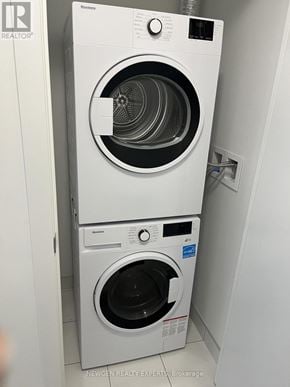Toronto (Banbury-Don Mills) condo for rent - A white washing machine is stacked on top of another white washing machine.