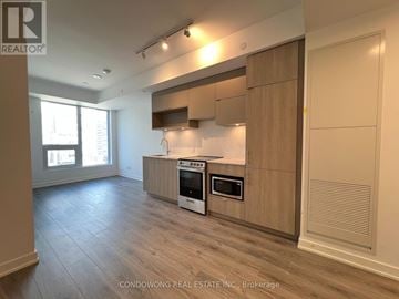 Toronto (Church-Yonge Corridor) condo for rent - A kitchen with wooden cabinets and a stove top oven.